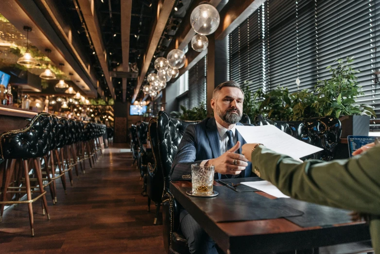 two men sitting at a table in a restaurant, pexels contest winner, holding court, thumbnail, lachlan bailey, completely empty