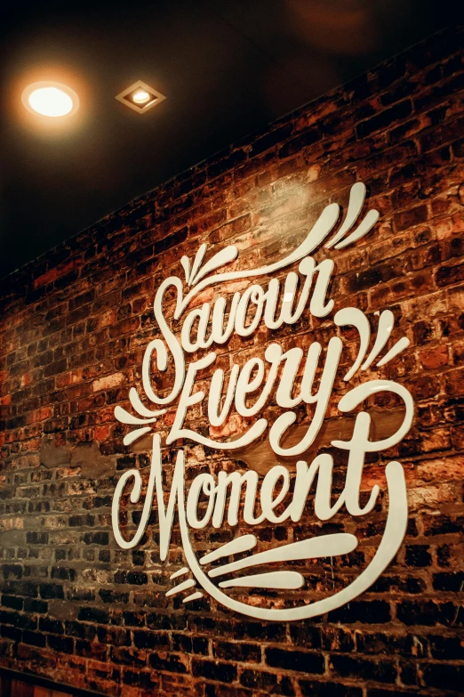 a sign hanging on the side of a brick wall, by Sara Saftleven, unsplash contest winner, graffiti, the happiest moment, cavernous interior wide shot, saturday night in a saloon, wow wow detail