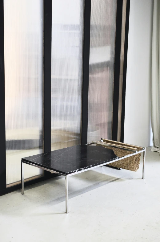 a black table sitting in front of a window, inspired by Constantin Hansen, modernism, black marble, made of brushed steel, kano), platform