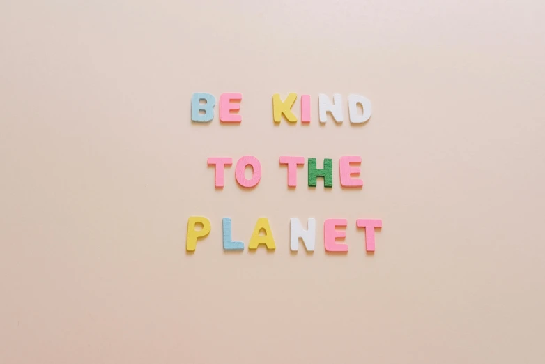 a sign that says be kind to the planet, trending on pexels, pastels, mini planets, profile image, made of rubber
