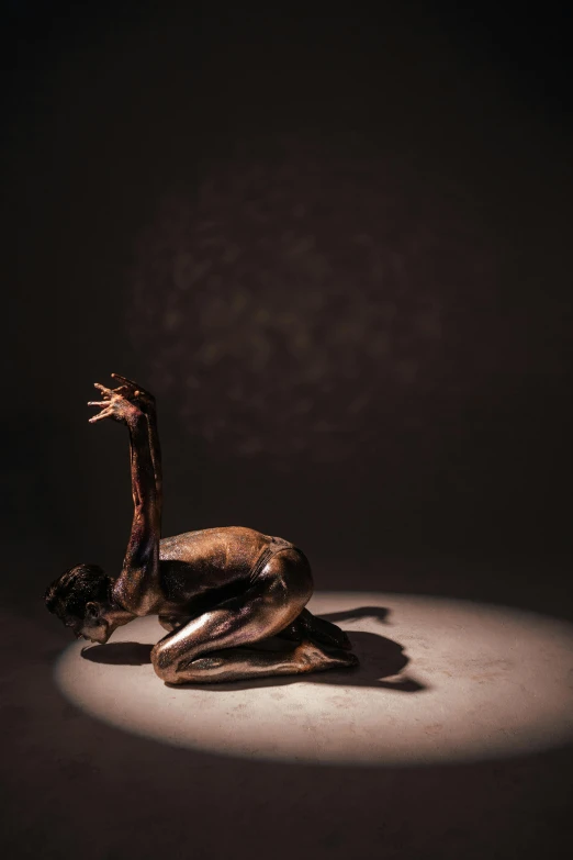 a dead animal laying on the ground in the dark, a bronze sculpture, by Elizabeth Polunin, contemporary dance, vivid)