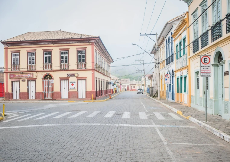 a red fire hydrant sitting on the side of a road, by Carey Morris, pexels contest winner, quito school, white houses, pastel hues, square, driving through a 1 9 5 0 s town