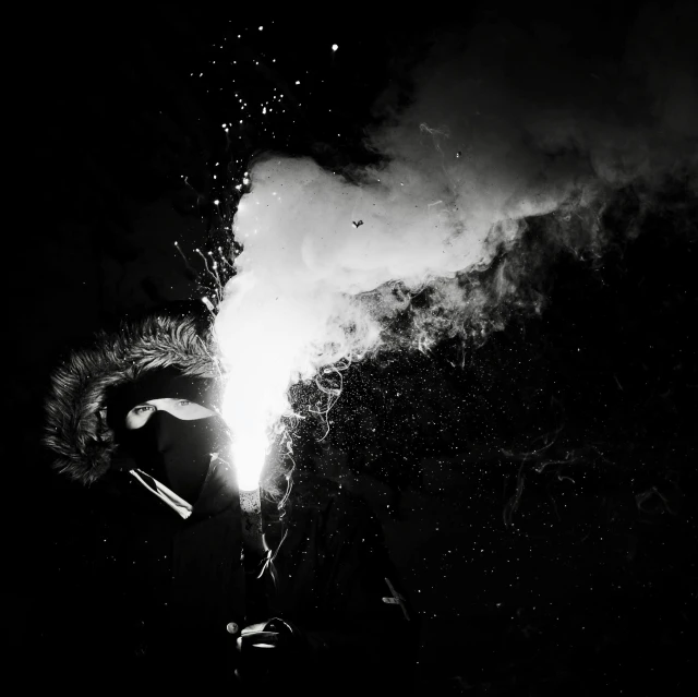 a black and white photo of a person holding a sparkler, by Caroline Mytinger, process art, metal album cover, medieval alchemist in the dark, welding torches for arms, glinting particles of ice