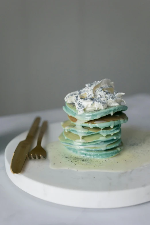 a stack of pancakes sitting on top of a white plate, a pastel, inspired by Barthélemy Menn, reddit, sea foam, titanium, stained”