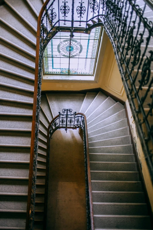 a spiral staircase with a skylight above it, by Nina Hamnett, unsplash contest winner, art nouveau, mansion, wide high angle view, square, hazy