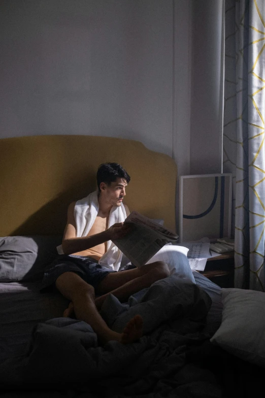 a man sitting on a bed reading a book, inspired by Nan Goldin, trending on reddit, hyperrealism, alessio albi and shin jeongho, lgbtq, backlight, taken in the early 2020s