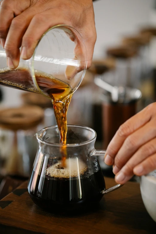 a person pouring coffee into a coffee pot, zoomed in, highly upvoted, glassware, bay area