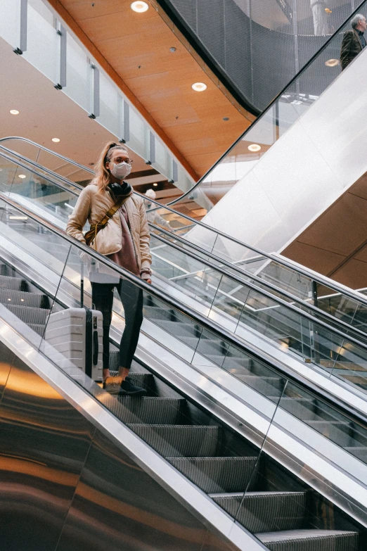 a woman standing at the bottom of an escalator, sustainable materials, thumbnail, australian, seasonal