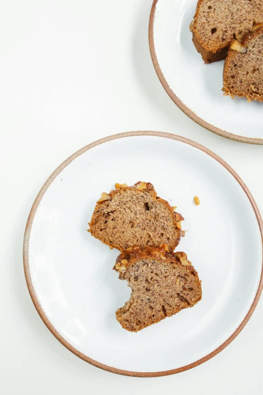 two plates with slices of banana bread on them, unsplash, renaissance, on white, square, organic detail, van