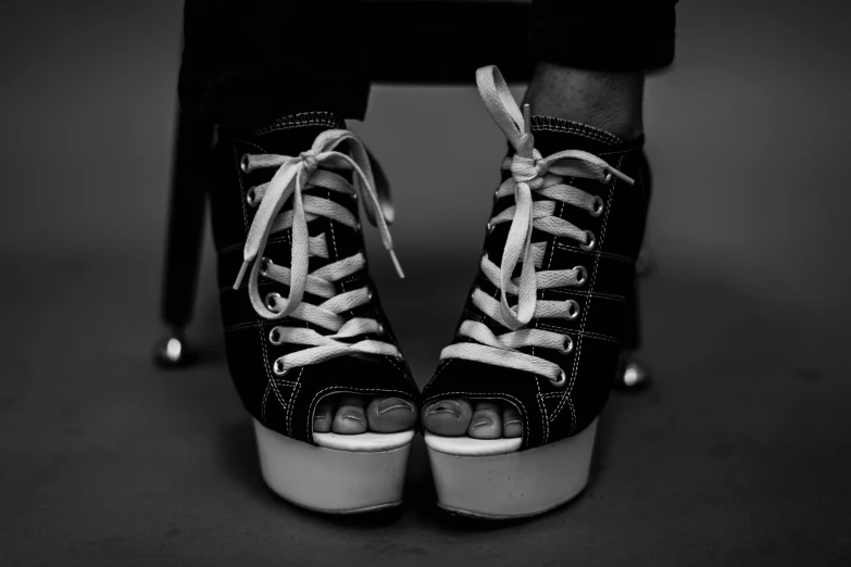 a black and white photo of a pair of shoes, punk girl, platforms, happy toes, photorealistic photo
