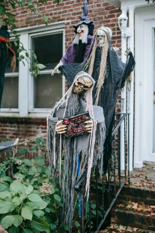 a couple of skeletons standing next to each other in front of a house, a statue, by Pamela Drew, pexels, apes hanging from vines, portrait of grim reaper, slide show, diverse costumes