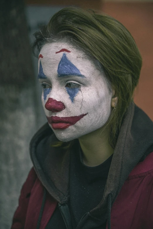 a woman with a clown face painted on her face, pexels contest winner, antipodeans, movie still of a tired, teenager, grunged up, small