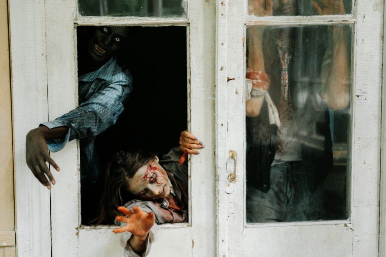 a couple of people that are sticking their hands out of a window, by Meredith Dillman, pexels contest winner, hyperrealism, call of duty zombies, leaning on door, halloween decorations