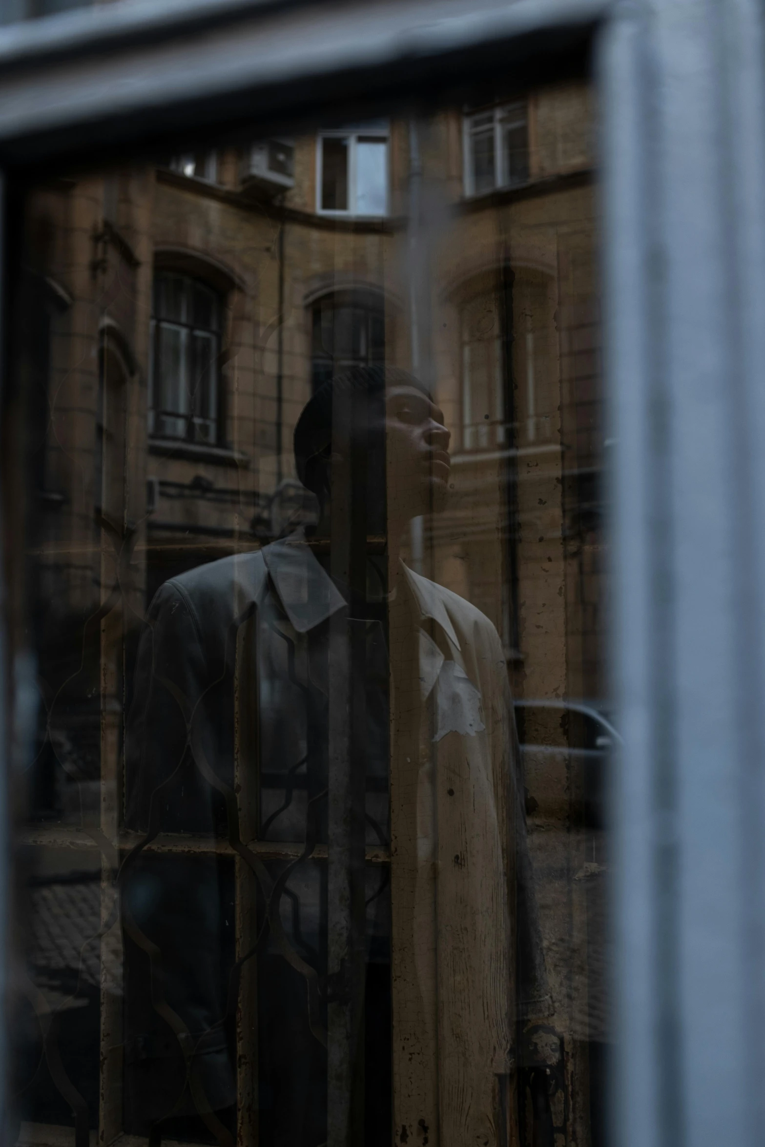 a reflection of a man in a suit in a window, a picture, by Raphaël Collin, pexels contest winner, renaissance, wearing a long beige trench coat, from the distance, cinematic shot ar 9:16 -n 6 -g, protagonist