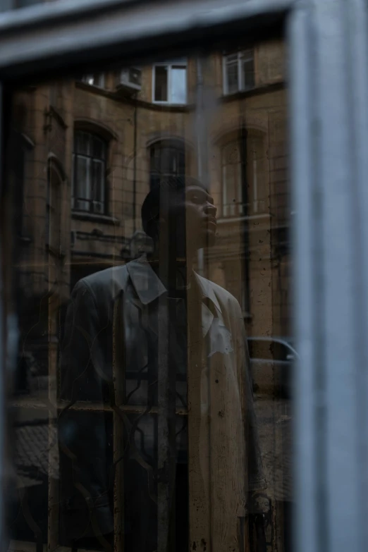 a reflection of a man in a suit in a window, a picture, by Raphaël Collin, pexels contest winner, renaissance, wearing a long beige trench coat, from the distance, cinematic shot ar 9:16 -n 6 -g, protagonist