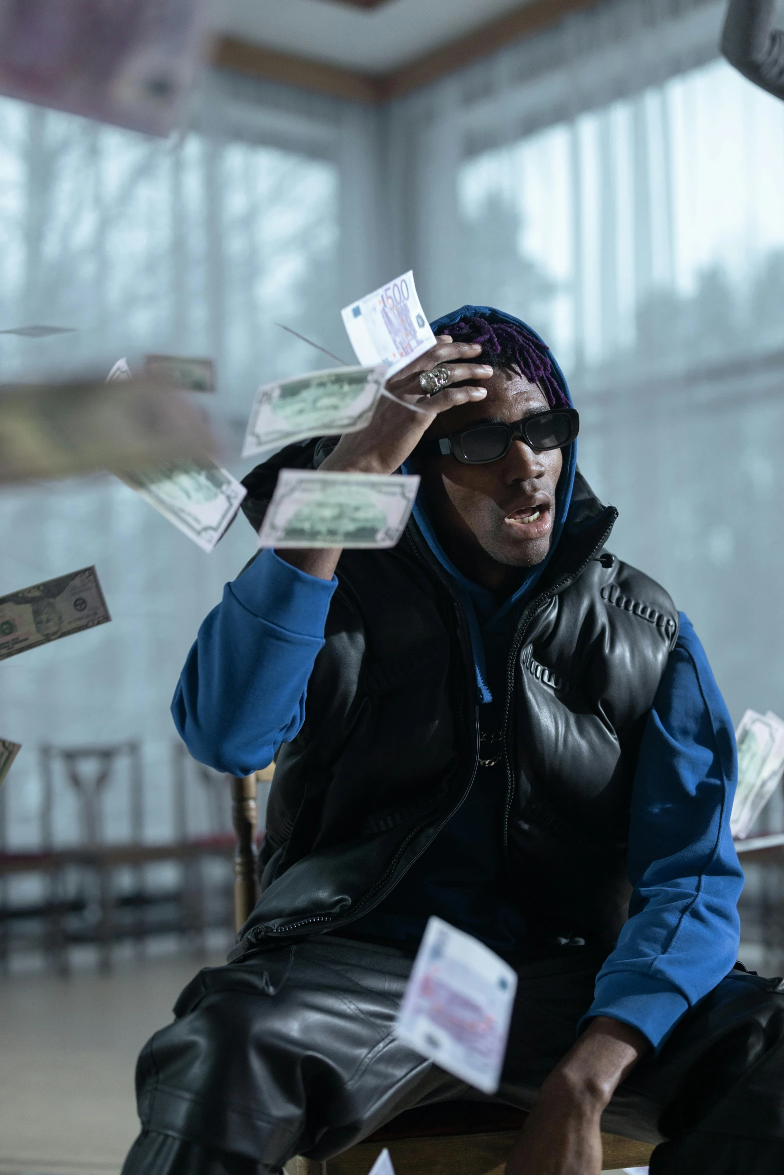 a man sitting in front of a pile of money, an album cover, pexels contest winner, visual art, ski mask, indoor scene, [ theatrical ], cold light