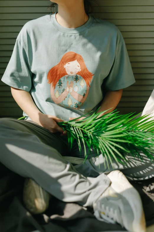 a woman sitting on the ground with a tennis racket, a cartoon, inspired by Ren Hang, trending on unsplash, wearing a marijuana t - shirt, long ginger hair, with potted palm trees, ((greenish blue tones))