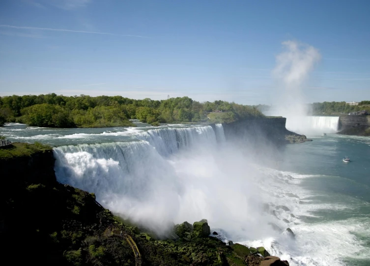 a large waterfall in the middle of a body of water, by Greg Rutkowski, pexels contest winner, hurufiyya, sweeping vista, national geograph, slide show, conde nast traveler photo