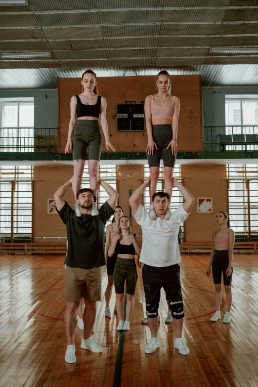 a group of people standing on top of each other, by Emma Andijewska, basketball, ilya ozornin, tiktok, high ceilings