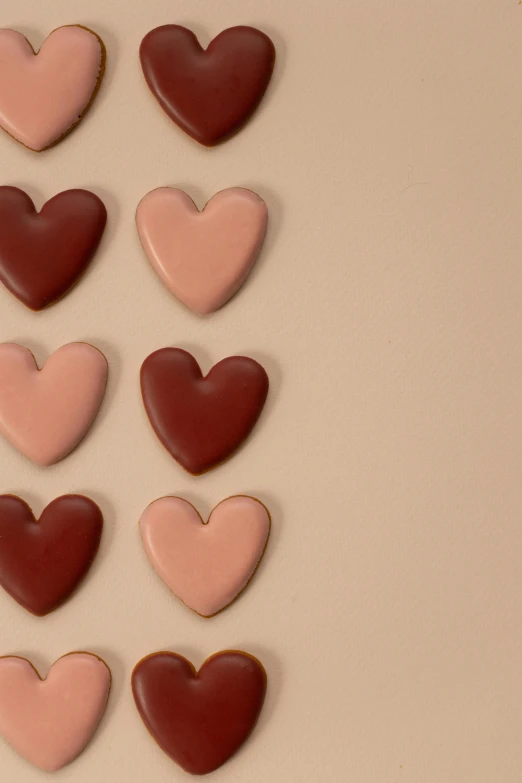 a white plate topped with lots of chocolate hearts, trending on pexels, warm muted colors, animation, terracotta, cookies