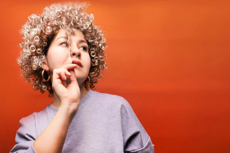 a close up of a person with a cell phone, an album cover, inspired by Elsa Bleda, hyperrealism, curly pixie hair, thinker pose, white and orange, calmly conversing 8k