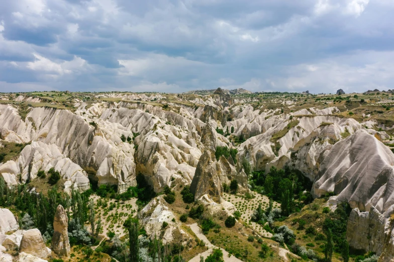 a view of the landscape from the top of a hill, by Muggur, pexels contest winner, art nouveau, chiseled formations, 2 0 0 0's photo, white marble buildings, cypress trees