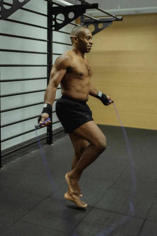 a man playing with a hula hoop in a gym, an album cover, reddit, figuration libre, ufc, hyperrealism photo, man walking, mike tyson