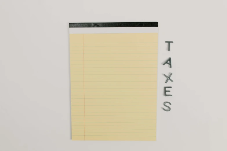 a piece of paper with the word taxes written on it, an album cover, by Adam Rex, conceptual art, minimalist poster art, clipboard, taken with sony alpha 9, walls with tone of yellow