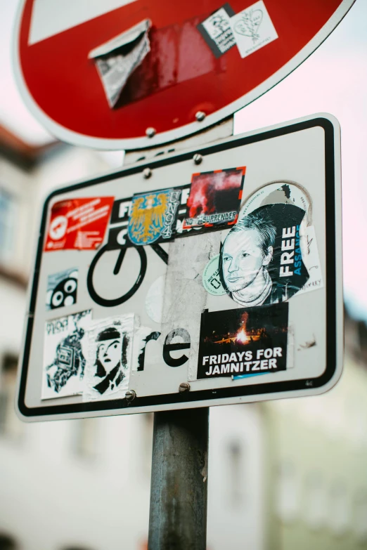 a close up of a street sign with stickers on it, a poster, trending on pexels, street art, magazine collage, anfree wallin, without text, center of image