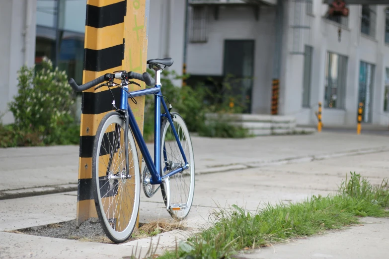 a bicycle leaning against a pole in front of a building, profile image, blue print, asphalt and metal, qiangshu