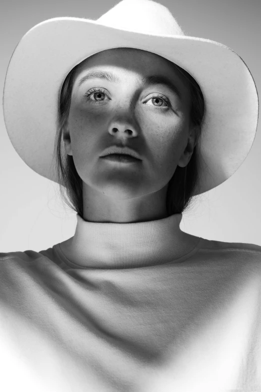 a black and white photo of a woman wearing a hat, inspired by Maud Naftel, unsplash contest winner, hyperrealism, white clothes, sydney sweeney, symetrical face, light from bottom