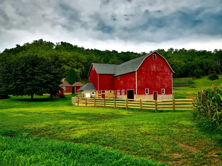 a red barn sitting on top of a lush green field, pexels contest winner, renaissance, overcast lighting, wooden houses, slide show, 2 0 2 2 photo