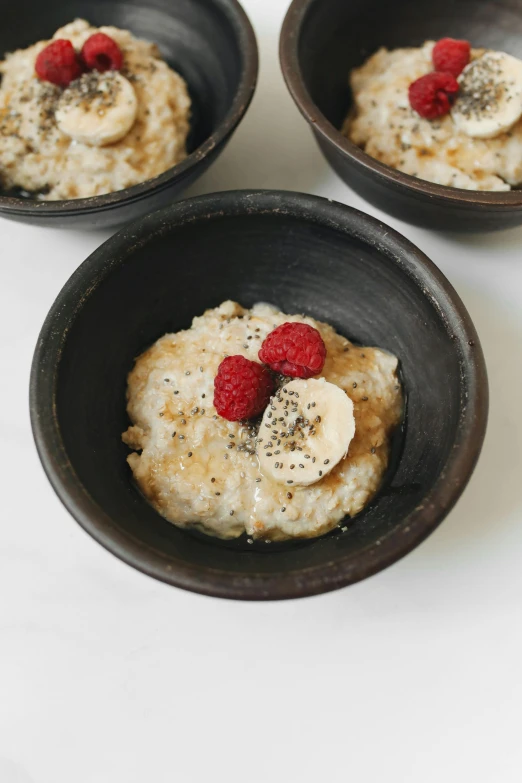 three bowls of oatmeal with bananas and raspberries, a portrait, by Alice Mason, unsplash, renaissance, made of glazed, petite, koju morimoto, detail shot