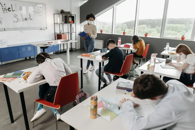 a group of children sitting at desks in a classroom, pexels contest winner, covid, paul barson, working in an office, profile image