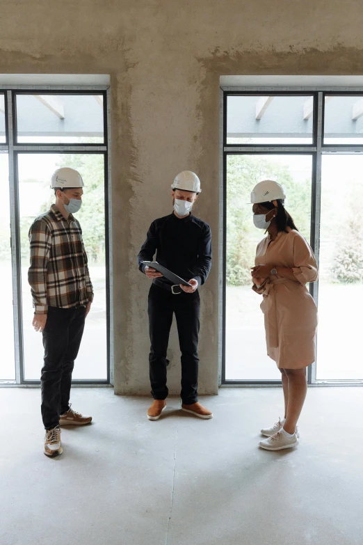 a group of people standing next to each other in a room, hard hat, profile image, architecture, masks