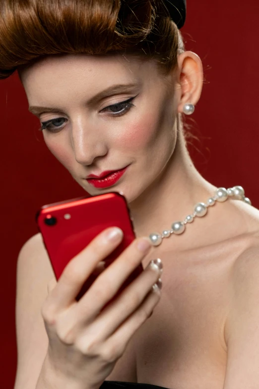 a woman in a black dress holding a red cell phone, opulent pearl necklace, profile image, red contact lenses, square