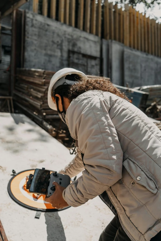 a man riding a skateboard down a sidewalk, pexels contest winner, arbeitsrat für kunst, holding wood saw, wearing a round helmet, inspect in inventory image, on the concrete ground