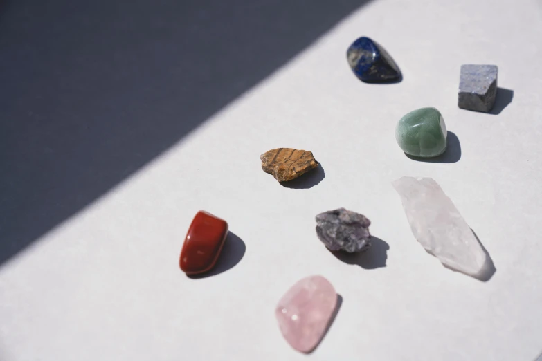 a group of stones sitting on top of a table, by Nathalie Rattner, trending on pexels, made of multicolored crystals, minimal artifacts, shot on 35mm, high quality product image”