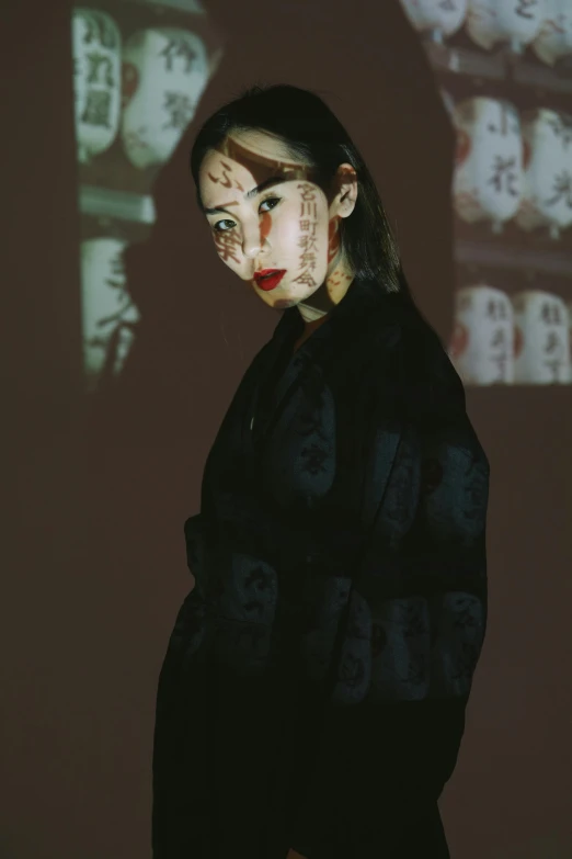 a woman standing in front of a projection screen, inspired by Zhang Xiaogang, unsplash, wearing japanese techwear, ethnicity : japanese, photographed on damaged film, ((portrait))