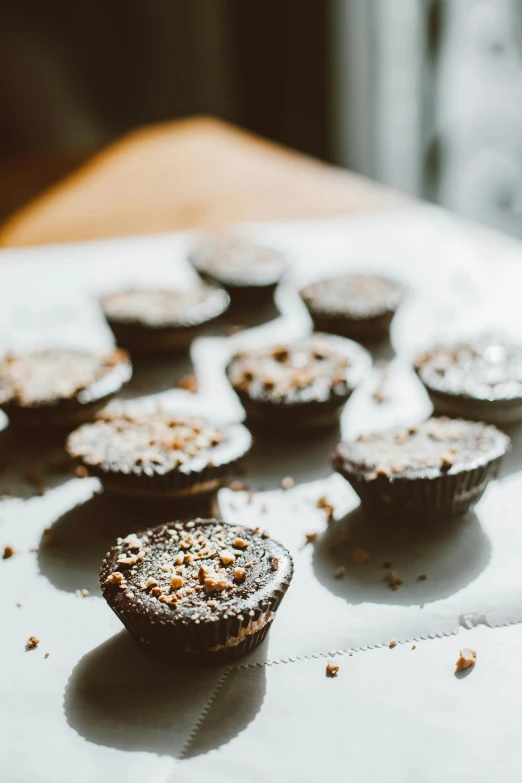 a bunch of cupcakes sitting on top of a table, by Jessie Algie, pexels contest winner, rocky roads, brunette, no cutoff, in a row