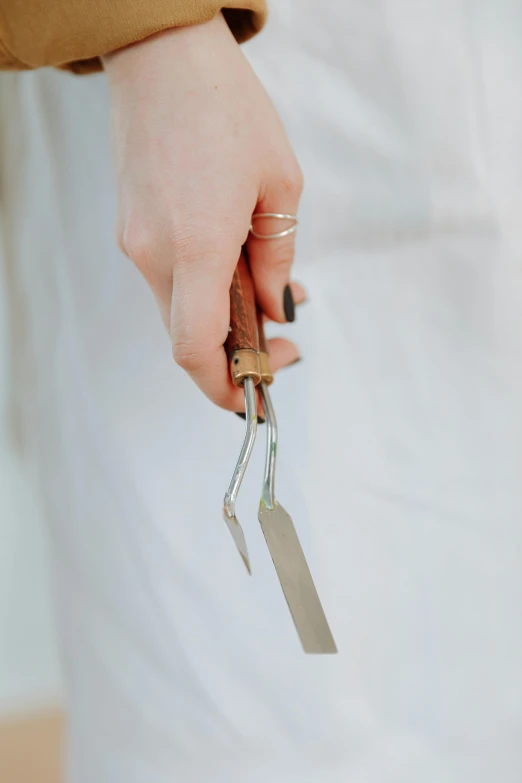 a close up of a person holding a knife, wooden jewerly, detailed product image, wedding photo, armature wire