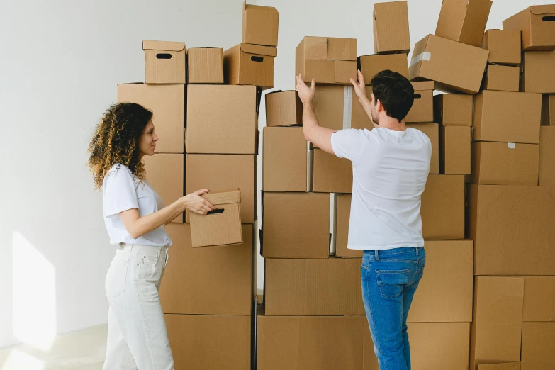 a man and a woman standing in front of a wall of boxes, repairing the other one, profile image, wallpapers, small