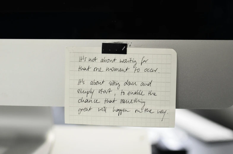 a note sitting on top of a computer monitor, by Jessie Algie, temporary art, photographed for reuters, curiosity, whiteboards, ignant