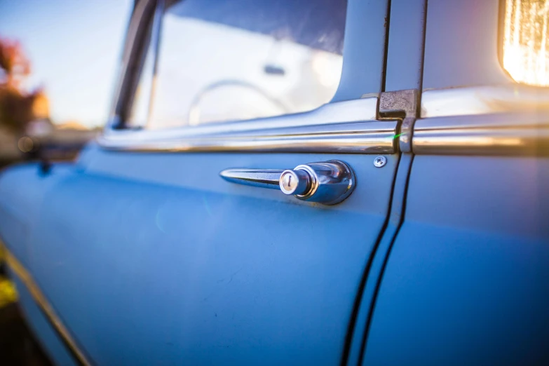 a close up of a door handle on a blue car, a portrait, unsplash, photorealism, 1957, looking to the right, instagram photo, various posed