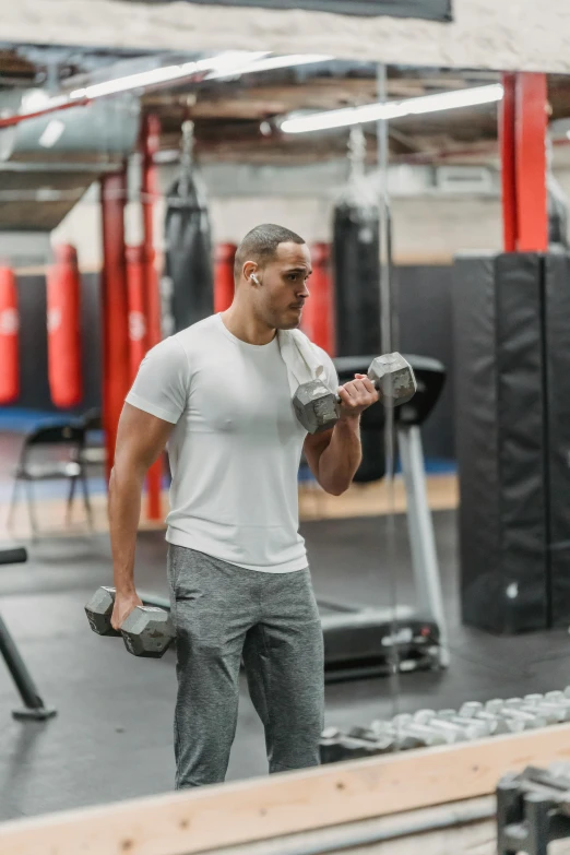 a man lifting dumbbells in a gym, happening, jayson tatum, accurate walk cycle, ca, commercial photo