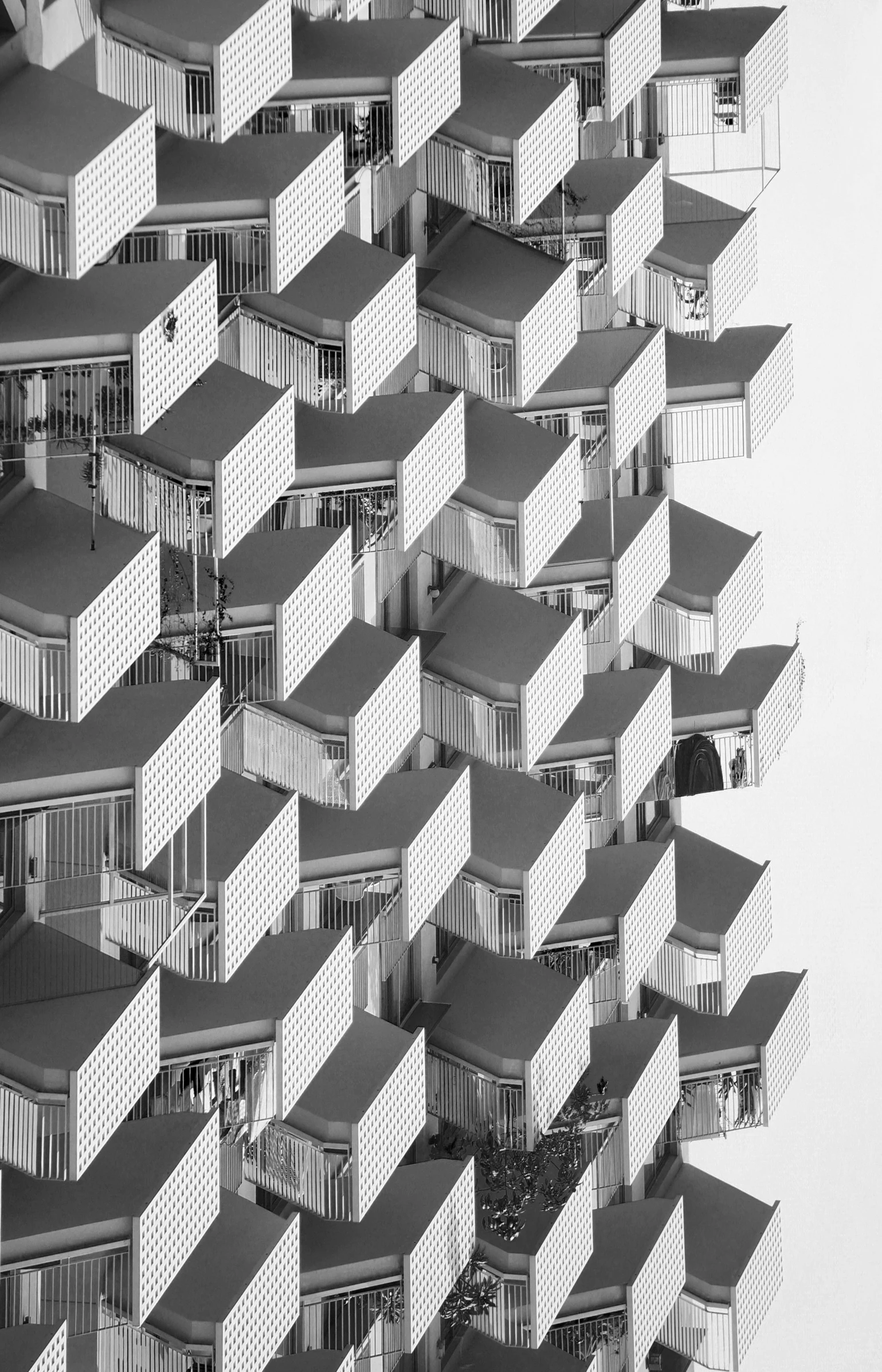 a black and white photo of a tall building, unsplash contest winner, brutalism, shipping containers, hives, tessellation, balconies