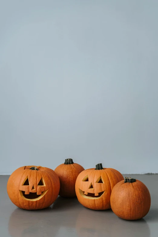 a group of pumpkins sitting on top of a table, pexels, minimalism, 256x256, smiling at camera, costume, f / 2 0