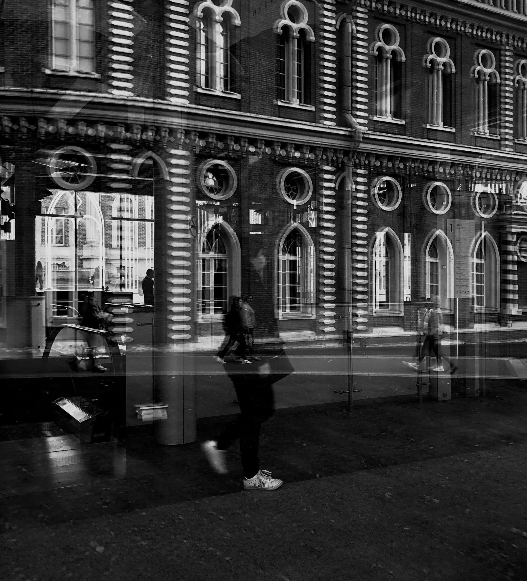 a black and white photo of people walking in front of a building, by Daniel Gelon, pexels contest winner, hyperrealism, street lights water refraction, square, anna nikonova, glasgow