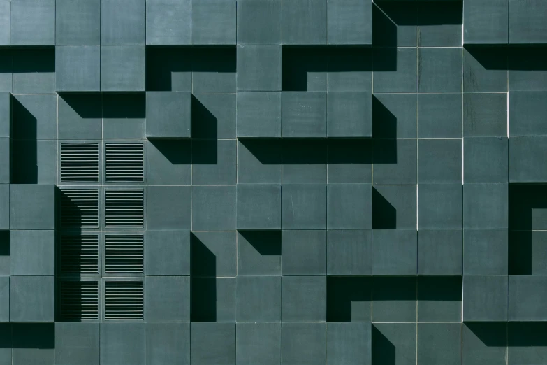 a person sitting on a bench in front of a building, inspired by David Chipperfield, flickr, brutalism, dark green tones, puzzle, close-up from above, tetris