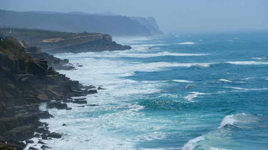 a large body of water next to a cliff, pexels contest winner, offshore winds, portugal, 2 5 6 x 2 5 6 pixels, where a large